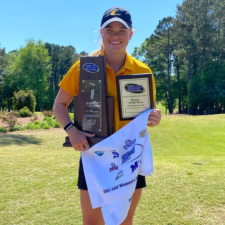 Rylee Suttor holding a tournament trophy at Centre College